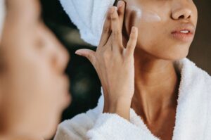 Close up of woman applying skincare products to face 300x199 - Close up of woman applying skincare products to face