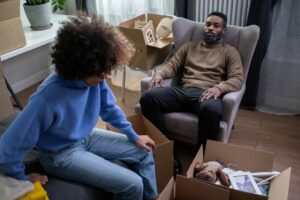Couple discussing with box on floor 300x200 - Couple discussing with box on floor
