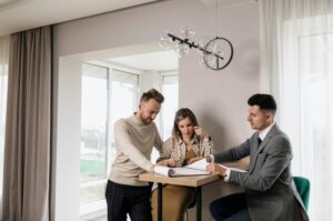 Couple signing papers with agent 2 300x199 - Couple signing papers with agent (2)