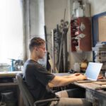 Home Man using laptop in a workshop 4 150x150 - Home