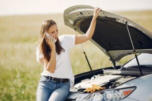 Woman talking to her phone while sitting on car 1 300x199 - Woman talking to her phone while sitting on car (1)