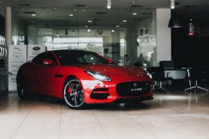 red sports car in showroom 300x200 - red sports car in showroom