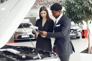 saleswoman with man looking at engine bay 300x199 - saleswoman with man looking at engine bay