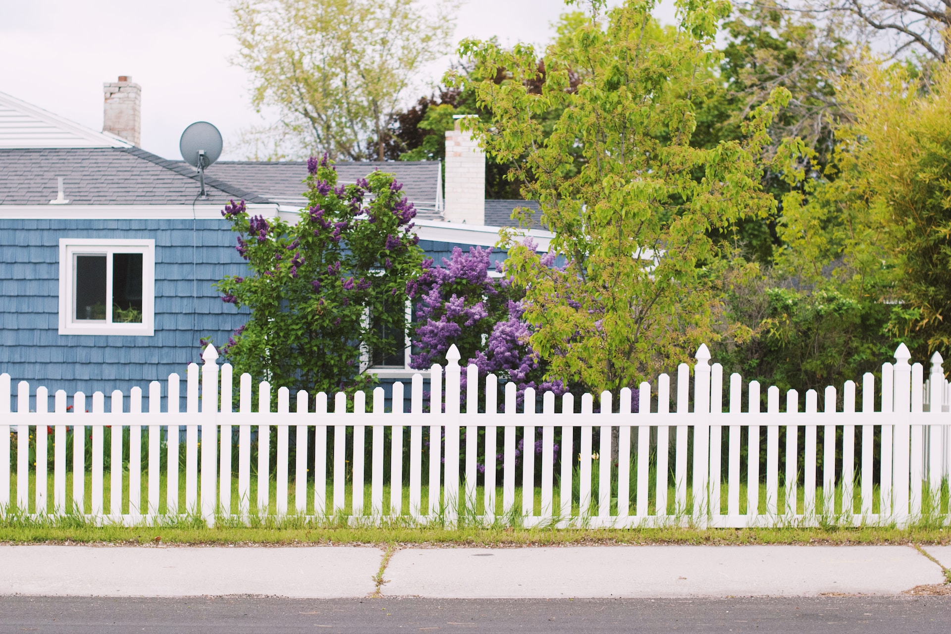 curved inward white fence - 9 Purposes of Fencing for Your Home