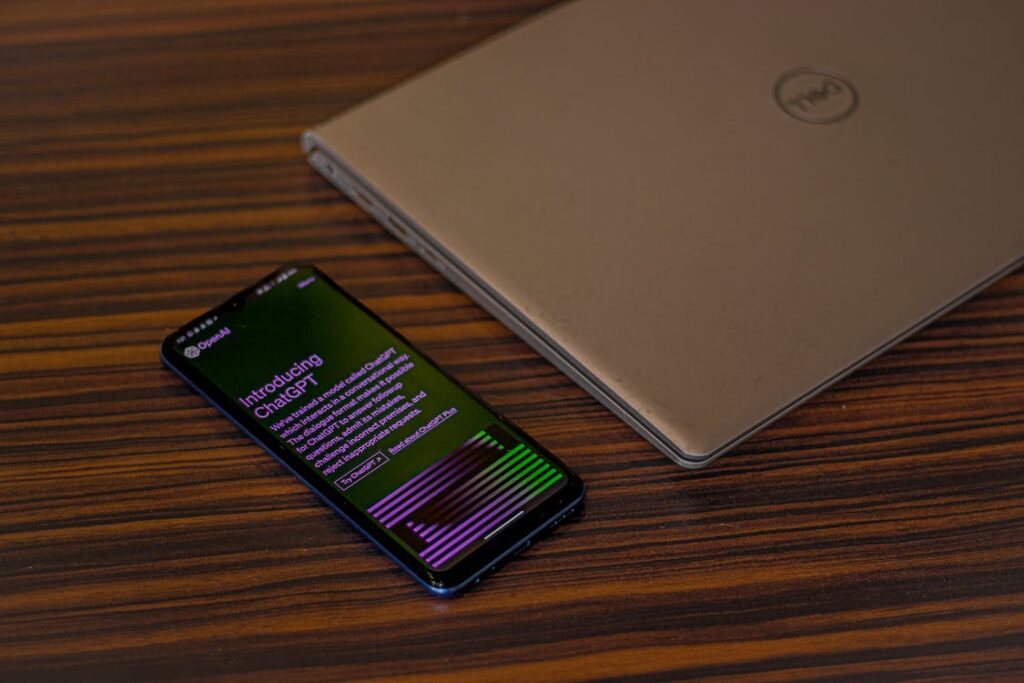 phone beside laptop opened to chatgpt homepage 1024x683 - 7 Ways to Streamline Work With ChatGPT