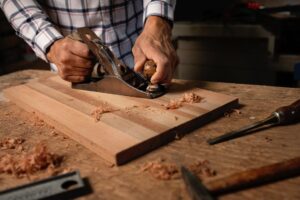 person planing thin wood block 300x200 - person planing thin wood block