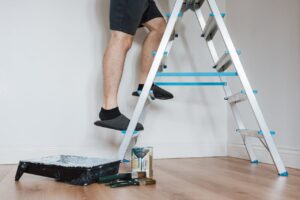 man climbing up on a stepladder 300x200 - man climbing up on a stepladder