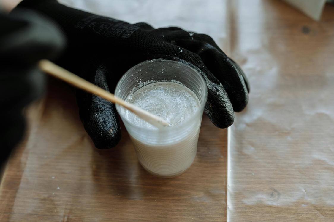 a person mixing a resin soloution - Picking a Plastic Injection Molding Company for Your Project