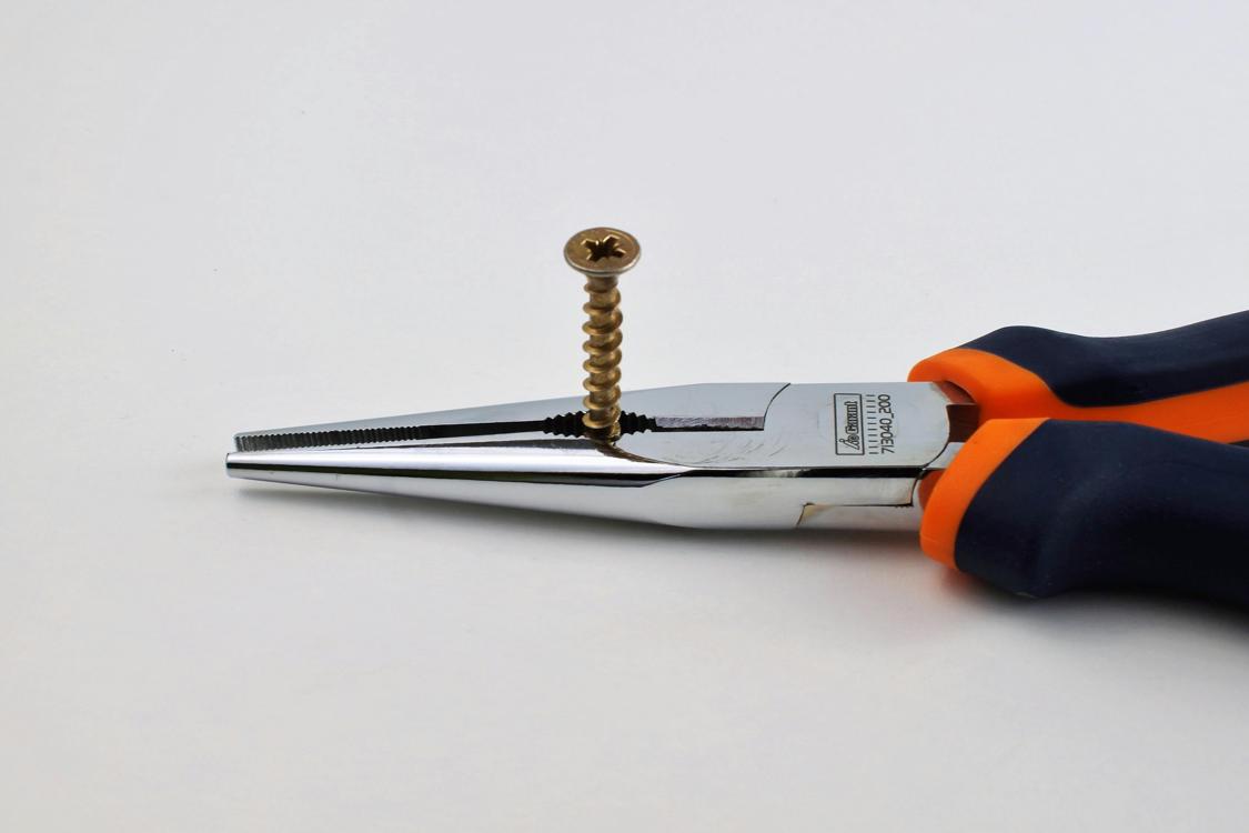 pliers and a screw - 6 Essential Plumbing Tools Listed And Expanded Upon