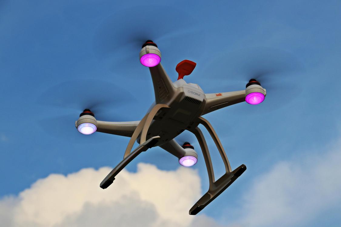 turnedon white quadcopter in the sky - The Mesmerizing World of Aerial Drone Photography