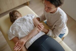woman lying on massage table having chiropractic therapy 300x200 - woman lying on massage table having chiropractic therapy