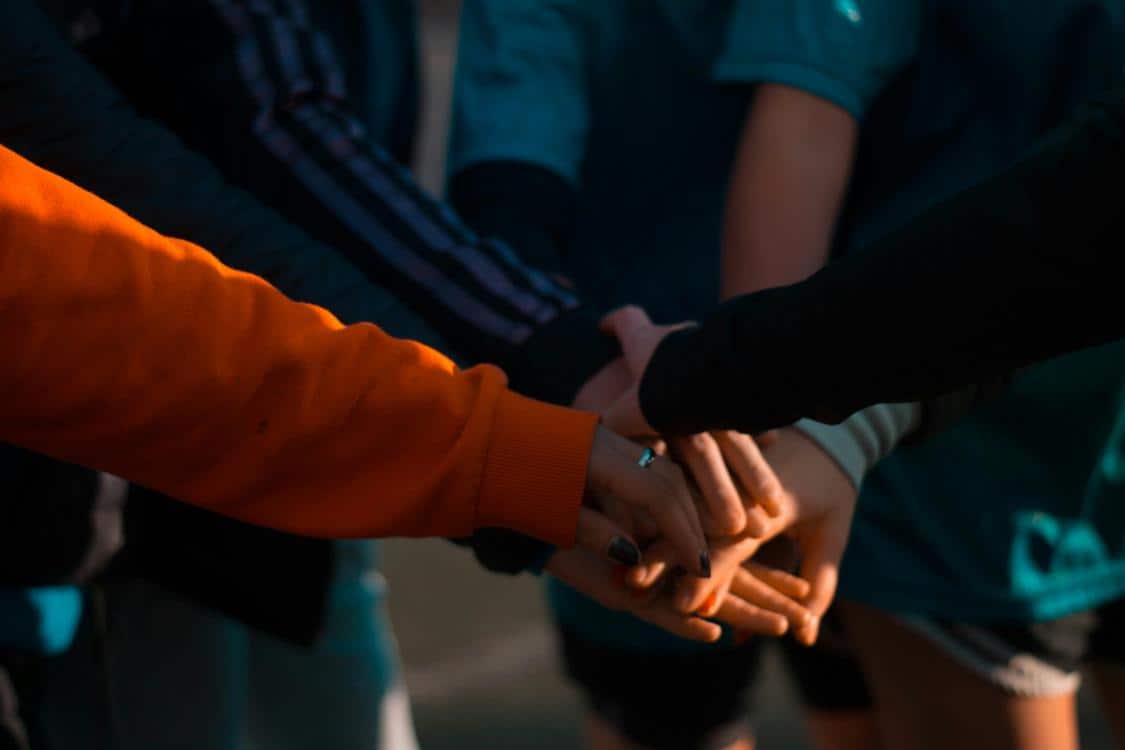 group of people huddling up - How to Interpret Dreams About Rings and Commitment