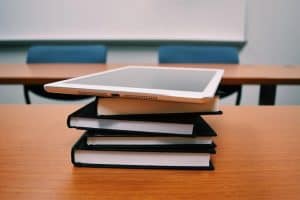 silver ipad on stack of books 300x200 - silver ipad on stack of books.jpg