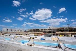a contemporary construction site under a vibrant blue sky with visible scaffolding and concrete foundations 300x200 - a contemporary construction site under a vibrant blue sky with visible scaffolding and concrete foundations..jpg