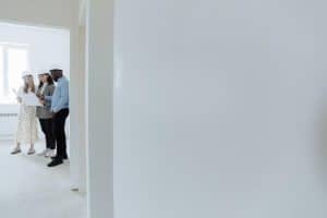 architects wearing hard hats review blueprints inside a building under construction 300x200 - architects wearing hard hats review blueprints inside a building under construction..jpg