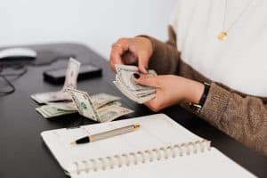 close up of person counting cash with notepad on desk  indicating financial tasks 300x200 - close-up of person counting cash with notepad on desk_ indicating financial tasks..jpg