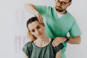 a chiropractor stretching a womans neck 300x201 - a chiropractor stretching a womans neck