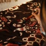 Home a woman decorating a fabric 150x150 - Home