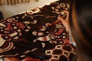 a woman decorating a fabric 300x201 - a woman decorating a fabric