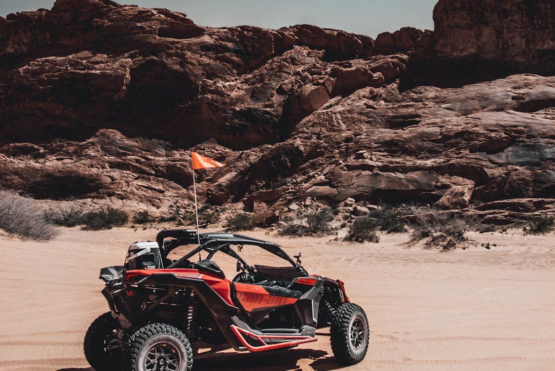 black and red UTV on desert - What Are UTV Whip Flags and Why Are They Important? Discover