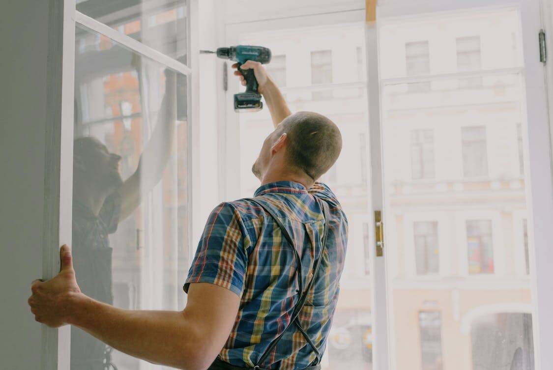 Handyman installing window frame - How to Assess if Glass Damage Needs Full Replacement