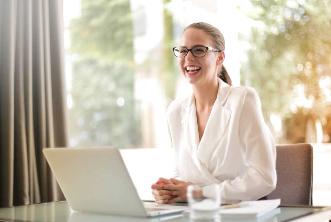 businesswoman working in office with laptop - How to Use Personal Growth to Reach Your Full Potential