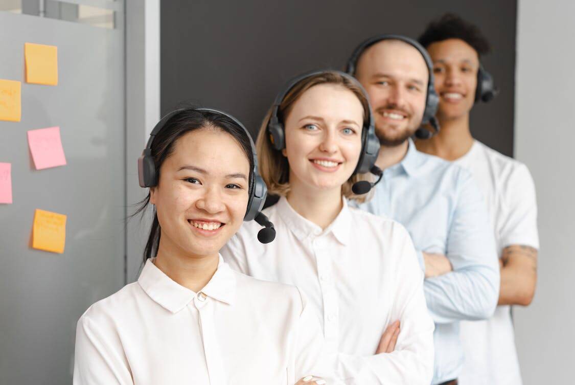 call center agents smiling - How Staffing Agencies Help During Seasonal Hiring Rush