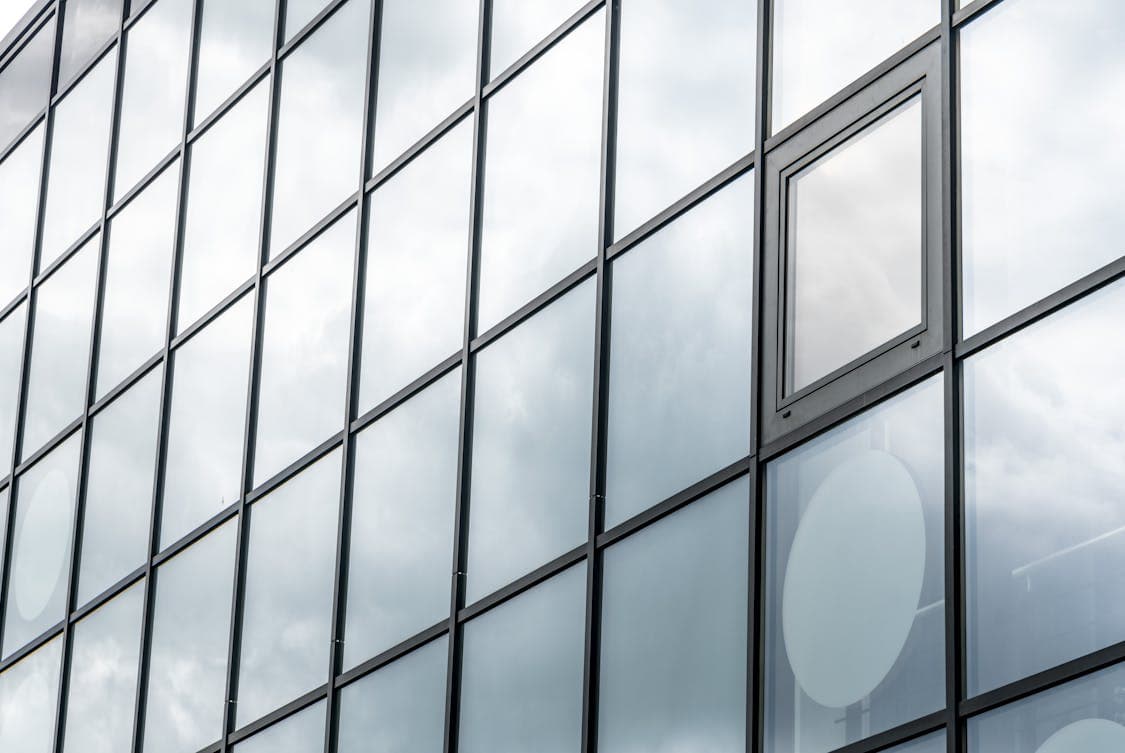 glass panels of a building - How to Assess if Glass Damage Needs Full Replacement