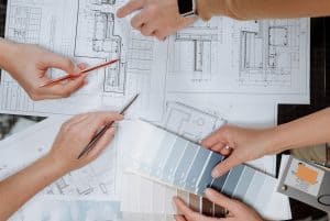 people working on a house plan 300x201 - people working on a house plan