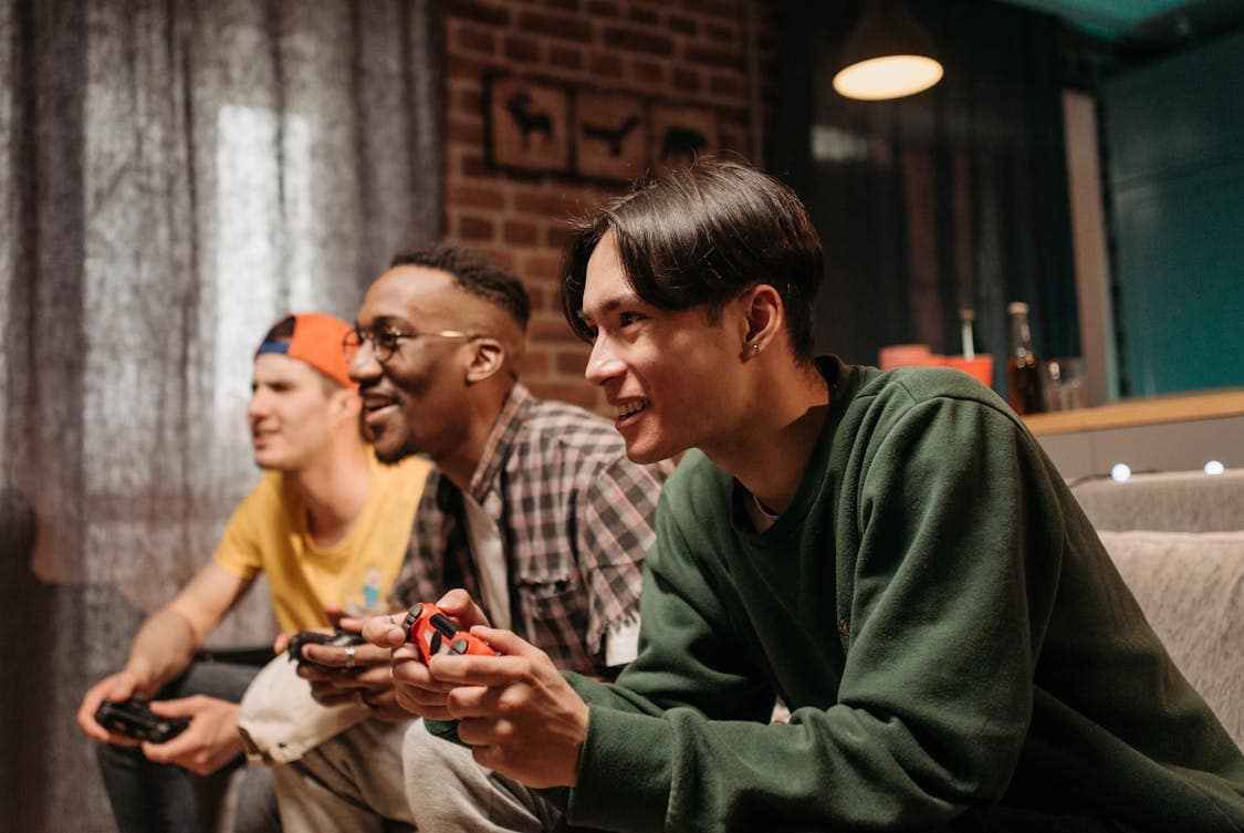 3 guys playing a video game - FC 26 Is Changing the Way Ultimate Team Rewards Are Earned