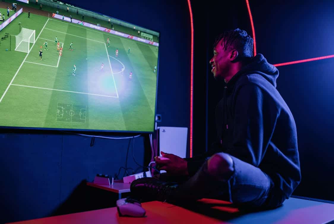 a man playing a video game - FC 26 Is Changing the Way Ultimate Team Rewards Are Earned