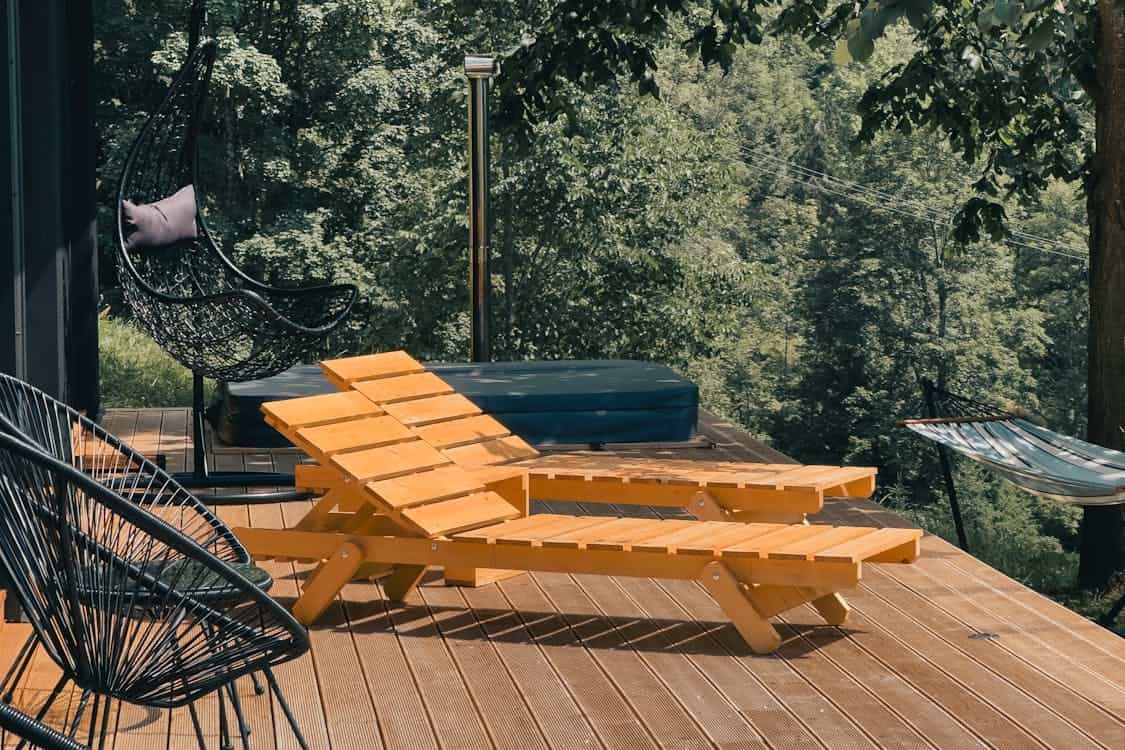 Outdoor Deck with Wooden Lounge Chairs - 5 Expert Tips for Choosing Timber Deck Materials Wisely