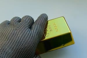 hand holding a gold bar 300x200 - hand holding a gold bar