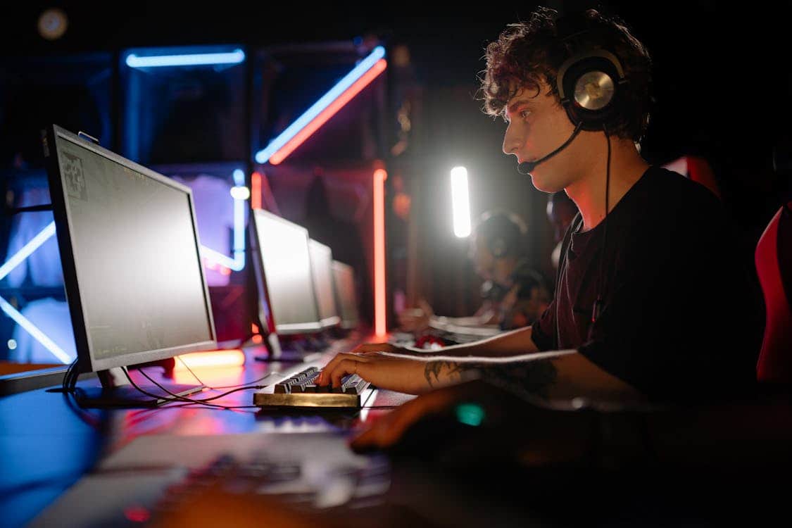 Why Cypher's Patch 11.08 Nerf Is Still the First Thing Valorant Coaches Address With Sentinel Mains Young man engaged in an immersive gaming - Why Cypher's Patch 11.08 Nerf Is Still the First Thing Valorant Coaches Address With Sentinel Mains