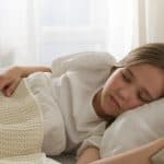 a young girl sleeping on bed 150x150 - Home