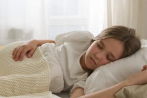 a young girl sleeping on bed 300x200 - a young girl sleeping on bed