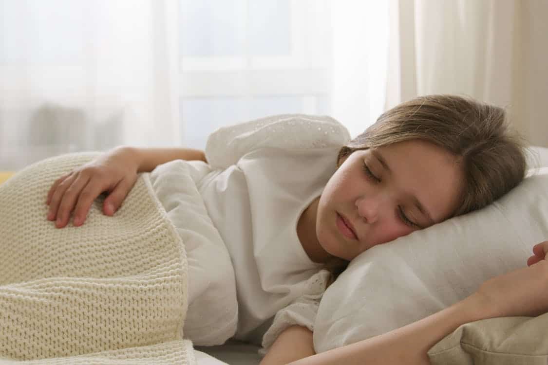 a young girl sleeping on bed - Children Need 9 to 11 Hours of Sleep to Grow Tall and Strong. Most Are Getting Far Less