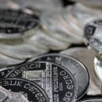 silver coins on a black surface 150x150 - Home