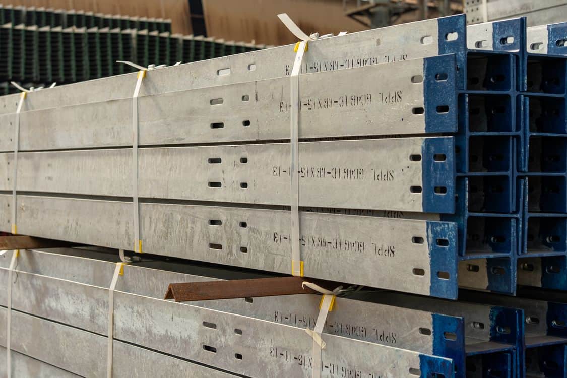 Close up of stacked metal beams - What the New Metals Tariffs Are Doing to Steel Costs on 2026 Industrial Job Sites