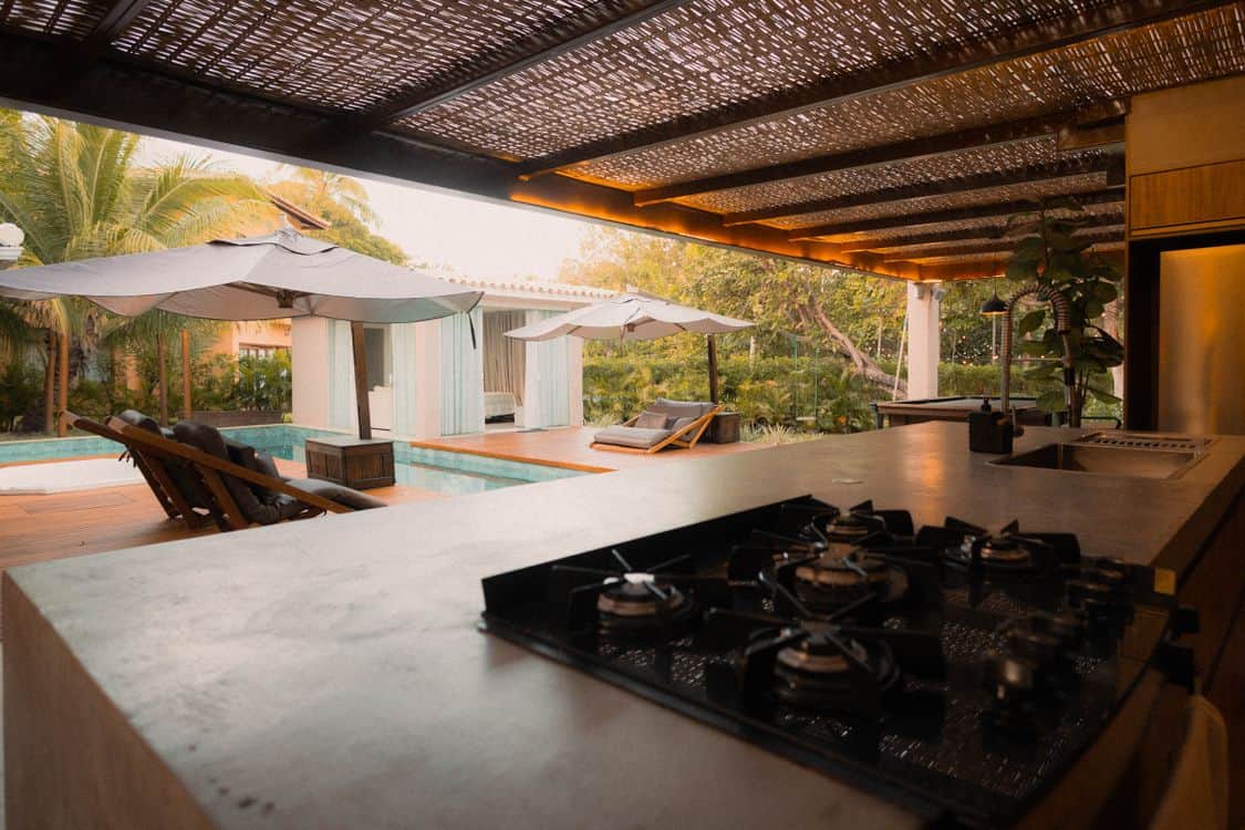 Modern outdoor kitchen overlooking a poolside setting - Why Las Vegas Backyards Are Winning the Renovation Budget Over Kitchens in 2026