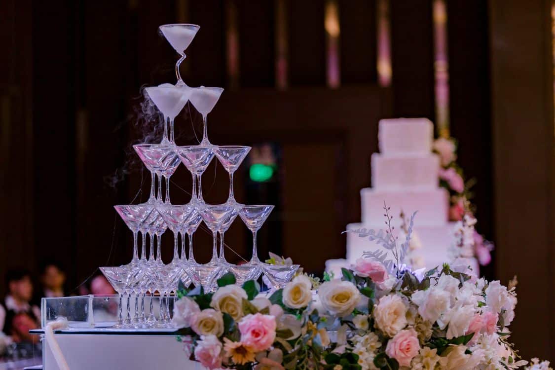 Home champagne tower with floral decor at a wedding reception - Home